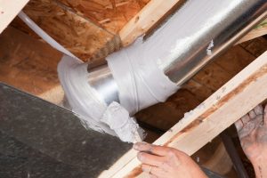 hand-applying-sealant-to-HVAC-duct